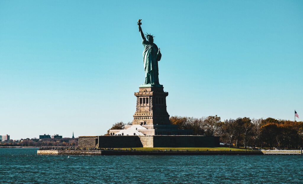 Vibrant depiction of the Statue of Liberty in New York City with a clear blue sky.